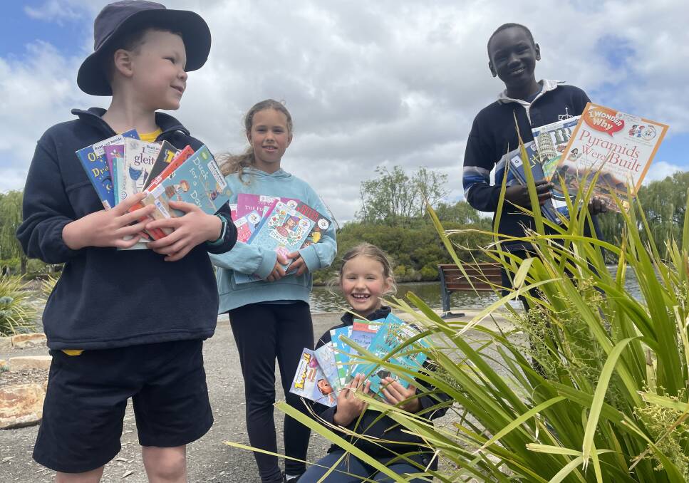 BOOK DROP: Rhylan Leehane, Lenka and Minay Grobbelaar and Ador Kongor with some of the book to be used in the Stawell Tuition book drop. Picture: TALLIS MILES