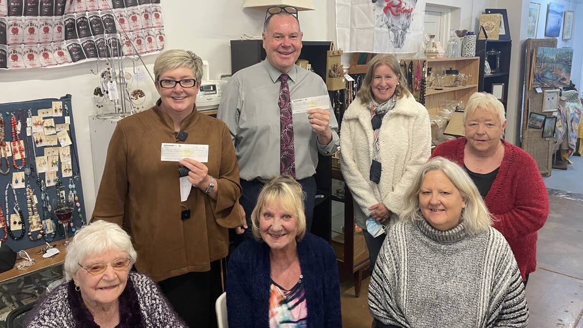 DONATIONS: Bookworm Gallery volunteers Pat Redman, Cherrelle Nicholson, Debbie Phillips, Hazel Bird and Helen Kennedy present Stawell Regional Health and Eventide Homes chief executive Gary Simpson with $15,000 donation each. Picture: TALLIS MILES 
