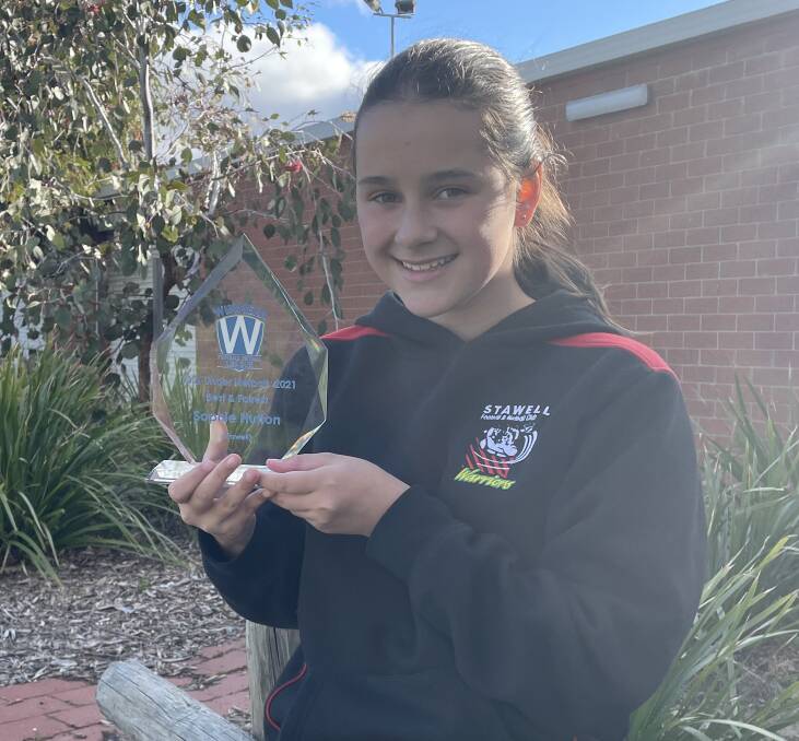 WINNER: Stawell Warriors' Sophie Hutton with the WFNL 13 and Under netball best and fairest trophy. Picture: TALLIS MILES