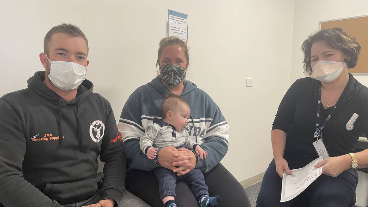 FIRST DOSE: Russell, Kylee, and baby Hugo Hodder at the Stawell Regional Health COVID vaccination walk-in clinic with nurse Monica Feder. Picture: TALLIS MILES