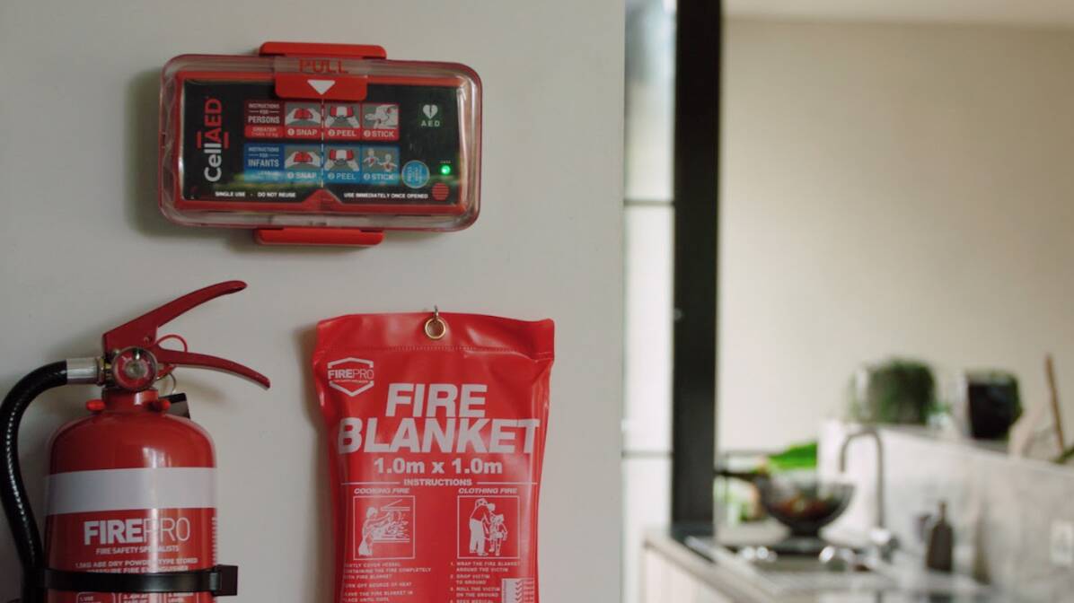 CellAED mounted on a wall above a fire blanket and extinguisher. Picture via CellAED
