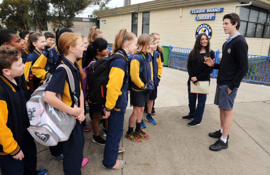VISIT: Horsham College students Tom Roberts and Buket Akiz take Horsham West Primary School grade 6 students on a tour of college. Picture: PAUL CARRACHER