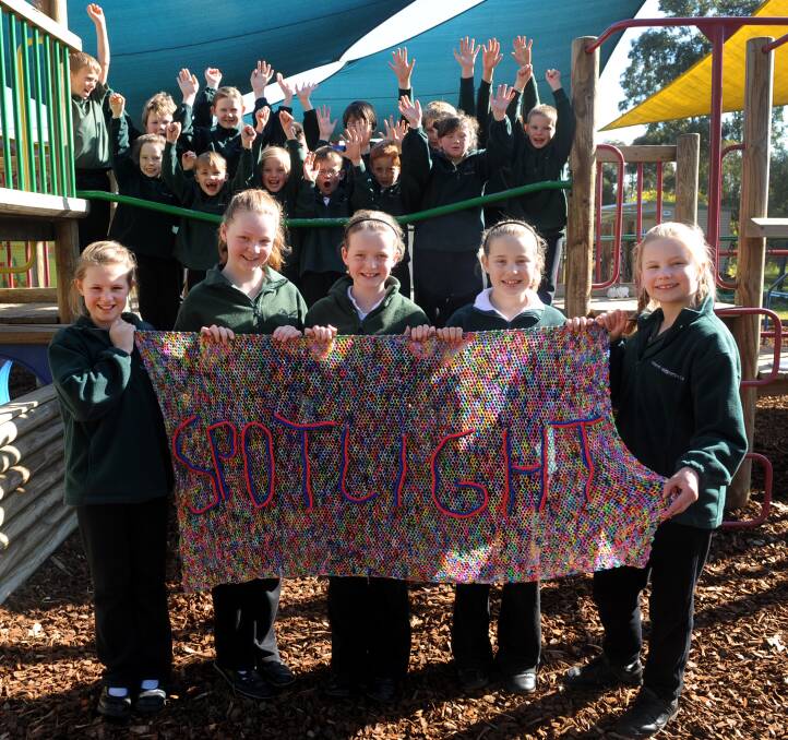 IN THE SPOTLIGHT: Great Western Primary School students celebrate as Jasmine, Elyza, Kendra, Tiarna and Ashley Basset hold the award winning loom band Ashley and her sister, Makala created. Pictures: SAMANTHA CAMARRI.