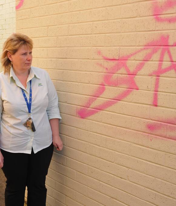 TAGGED: Madec's Wendy Mitchell inspects the back of the office on Main Street at Stawell, which was left damaged by graffiti on Wednesday. Picture: Grace Bibby