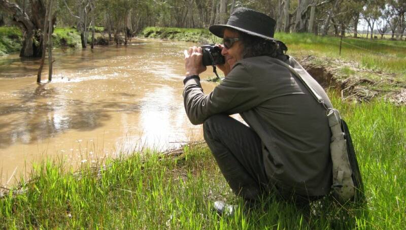 SNAPPED: Chris Nicholls takes in a shot while on a photography exhibition. Picture: Ros Nicholls