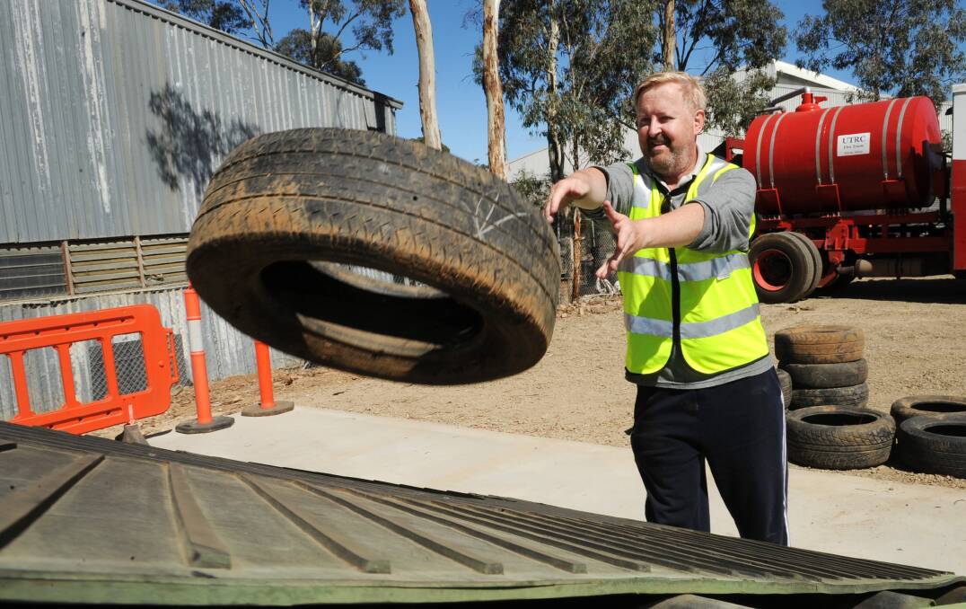 Used Tyre Recycling Corporation chief executive Matthew Starr gets to work. Picture: PAUL CARRACHER