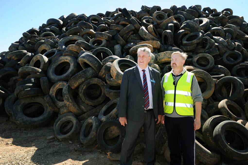 Northern Grampians Mayor Murray Emerson and Used Tyre Recycling Corporation chief executive Matthew Starr in front of the tyre stack. Picture: PAUL CARRACHER