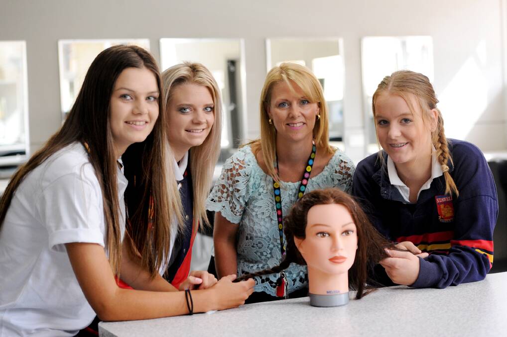 Stawell Secondary College year 11 students Heidi Chatfield, Molly-Rose Cameron, Kasey Bibby-Rickard with teacher Sonya Seehusen. The school has a new VETIS Hair and Beauty Program this year. Picture: SAMANTHA CAMARRI