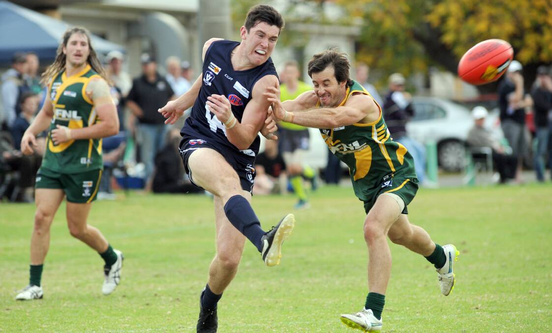STRONG FORM: Wimmera player Kieran Delahunty is chased hard by Sunraysia's Kane Dawson. Picture: PAUL CARRACHER