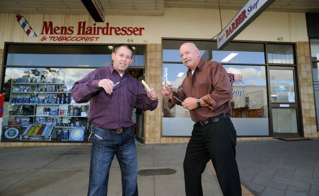 FRIENDLY RIVALRY: Grant Ross and Peter Pickering operate barber shops beside each other in McLachlan Street. Picture: PAUL CARRACHER
