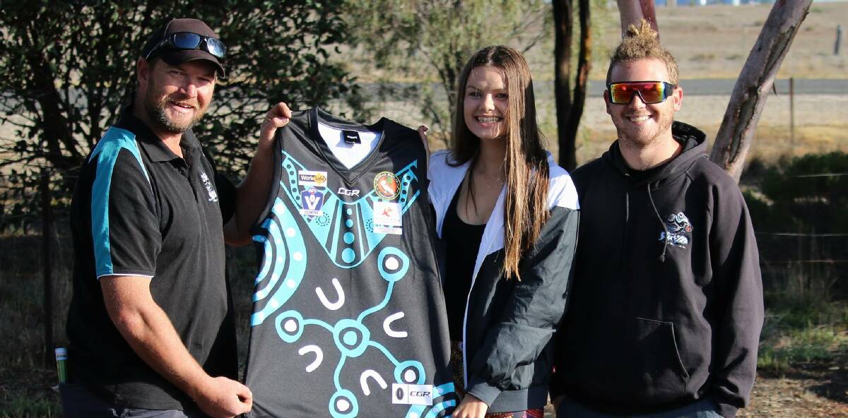 Proud: Steve Hoffman, Heidi Chatfield and Jordy Ralph hold the jumper Chatfield designed for the Indigenous round between Swifts and Taylor's Lake. Picture: Trish Ralph