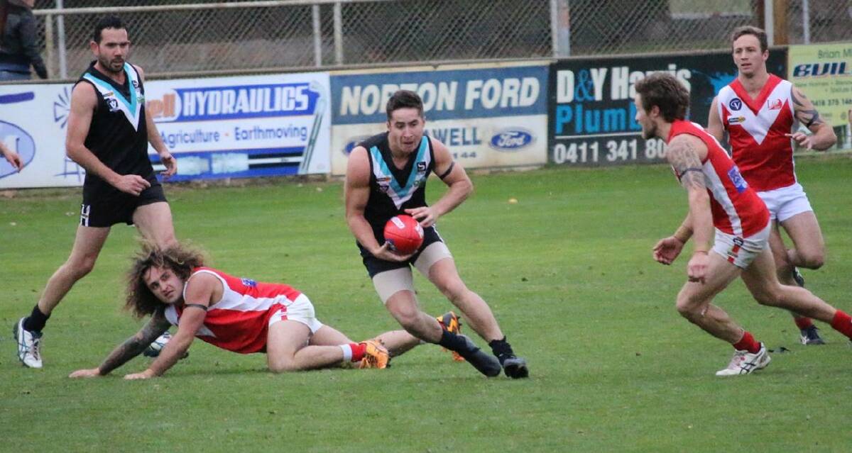 UP THE MIDDLE: Sean Mantell splits the Taylors Lake defence. Swifts went on to win the match by two points, Mantell sealing the victory with a late goal. Picture: TRISH RALPH