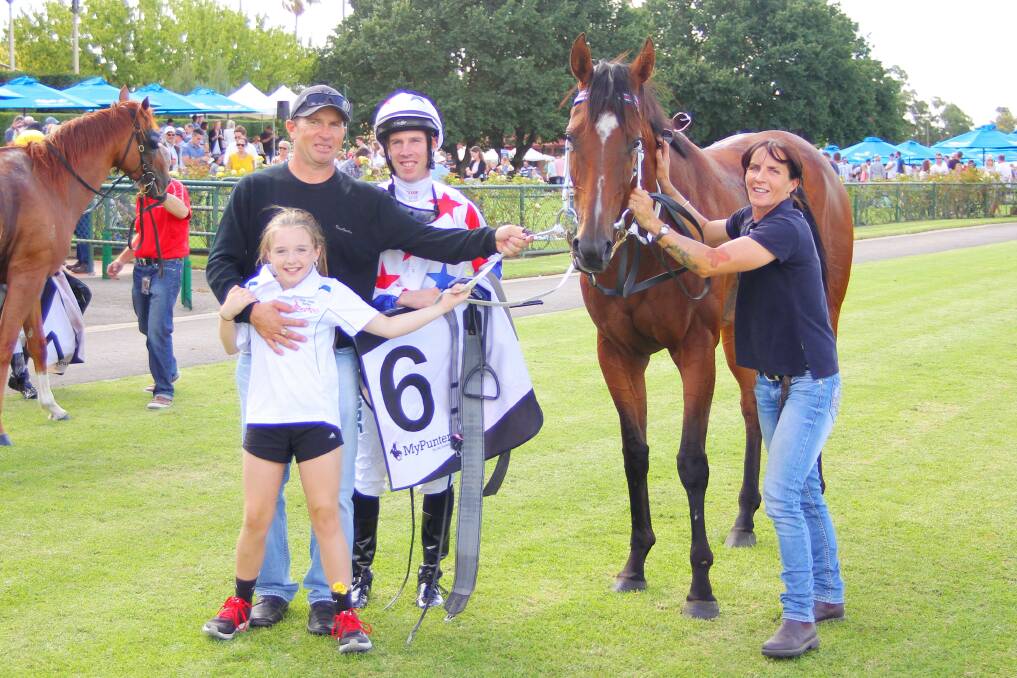 Good times: Stawell trainer Dane Smith celebrates Our Dexter's victory with jockey John Allen, daughter Jade and wife Heidi. 