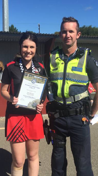 Honoured: Tessa Mornane is all smiles after receiving her award from Stawell  Policeman First Constable Craig Fribence.