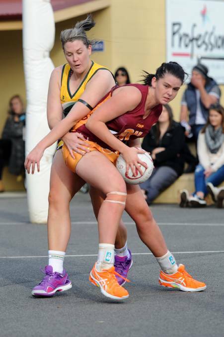 Young gun: Navarre's newly appointed joint coach Taylor Mason shows her strength and size for her age against Caitlin Story in the interleague clash last season.