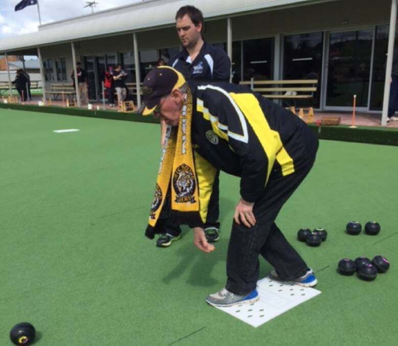 On the green: Damian Sheahan donned on his Richmond gear playing bowls at the All Abilities Bowls event hosted by Stawell Bowling Club with Locky Smith from Sports Central looking on.