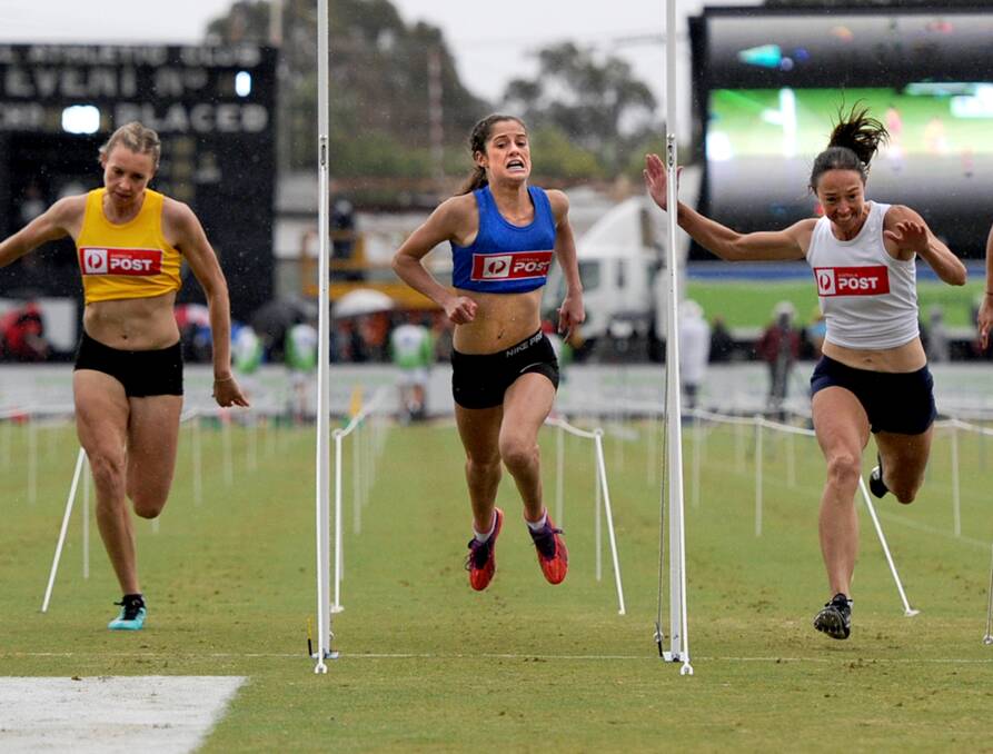 Full stretch: Grace O'Dwyer (blue) pushes her self to the limit in the 2015 Australia Post Womens Stawell Gift. O'Dwyer will be back to defend her title at the Stawell Gift in March