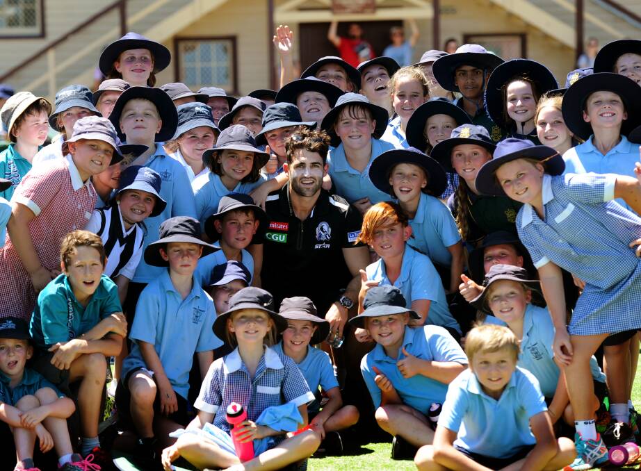 Favourite: Collingwood footballer Alex Fasolo is mobbed by young Collingwood fans from Stawell Primary School, St Patricks and Stawell West at a football super clinic at Central Park. Picture: Sam Camarri
