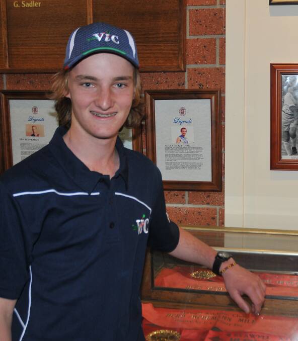 Aspiring: Young cross country athlete Tom Walker takes time out to admire some long distance running achievements at the Stawell Athletic Club. Picture: GRACE BIBBY