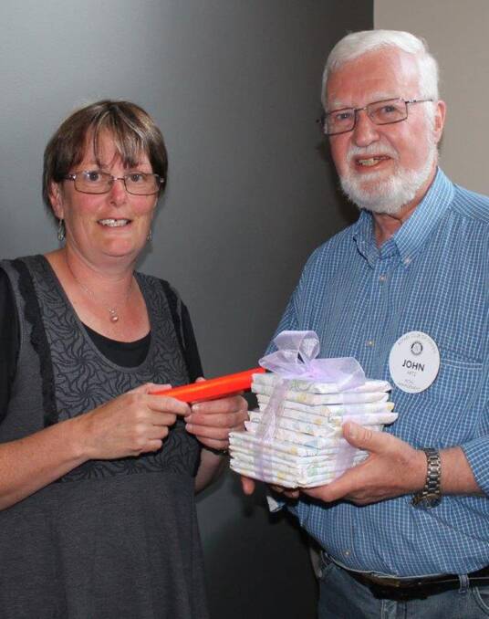 Special guest: Stawell Maternal and Child Health Nurse Sue Boag receives her gifts from Rotarian John Artz following her address to members of the Stawell Rotary Club.