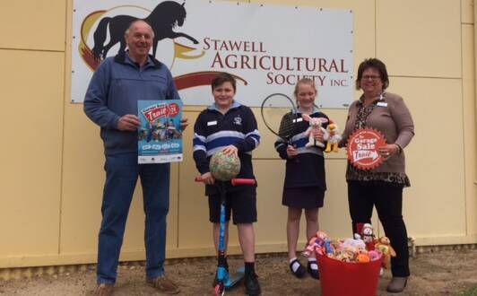 FOR SALE: Stawell Show committee president Geoff Erwin and 502 principal Robyn Jones with 502 students Myles and Tahlia promoting the school’s Garage Sale Trail stall which will feature at this year’s Stawell Show.