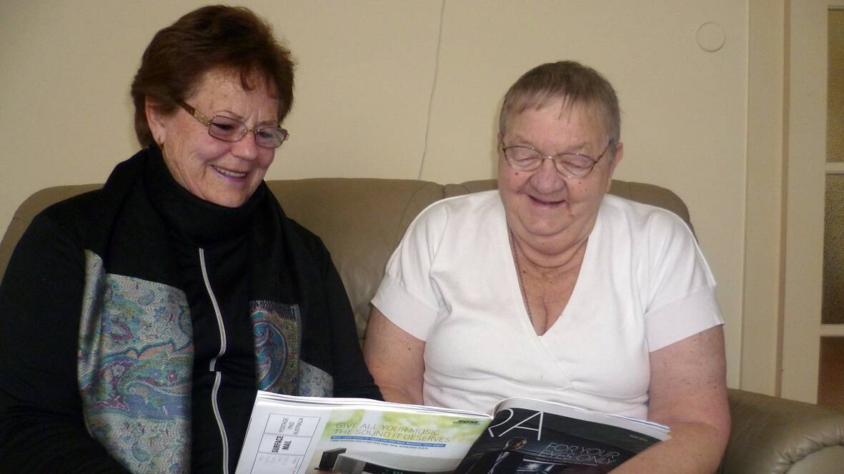 CARING: Marlene and Beryl enjoy reading together which is one of many  services provided by the Grampians Community Health Do Care Volunteer program.