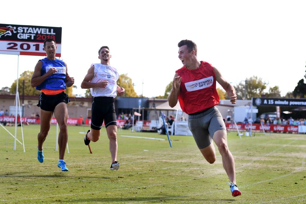HISTORIC: Jacob Despard is all smiles after winning the 2018 Stawell Gift on Monday, ahead of Gary Finegan and 2017 winner Matthew Rizzo. Picture: Samantha Camarri