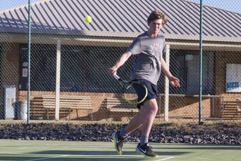 SET: Tim Hartwich gets his backhand show away during the first round of the new Wednesday night tennis season. Picture: Peter Pickering