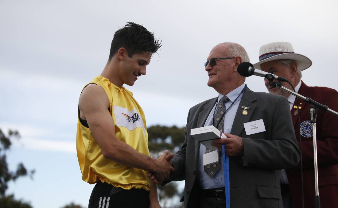 Bill Earle presenting the Gold medal to last year's Gift winner Matt Rizzo. 