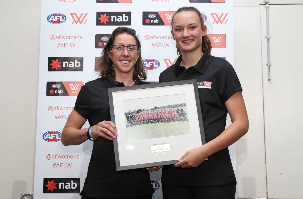 HONOUR: AFL Women's Academy assistant coach presents Georgia Clarke with her academy photo.
