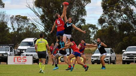 Kalkee's Doug Grinning and the Swifts' Brett Hargreaves
battle it out in the ruck. Picture by Ben Fraser