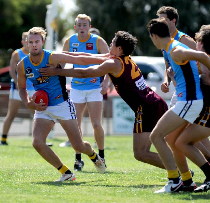 STIFF ARM: Nhill Tiger Thomas Wheelen shrugging off a challenge against the Warrack Eagles in the match-up between the two sides in round one. Picture: SAMANTHA CAMARRI