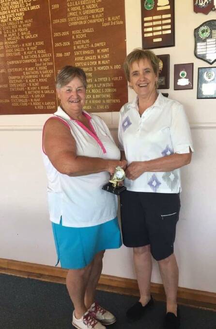 RAPT: Stawell Golf Club women's captain Carole McKendrick hands Jill McInerney her hole-in-one trophy. Picture: Contributed. 