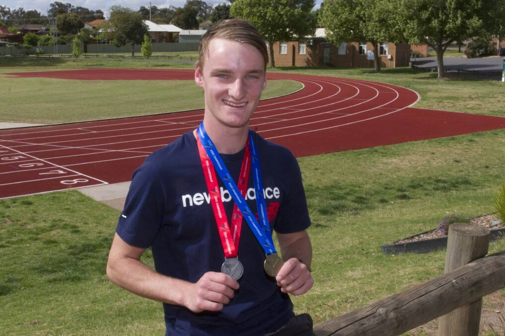 WINNING GRIN: Tom Walker with his silver medal won in the 17-year-old 1500m and his gold medal from his open age 3000m victory. Picture: Peter Pickering. 