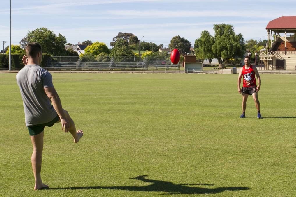 WARMING UP: Stawell's 2017 best and fairest winner Sean Mantell kicks the ball to new assistant coach Damian Joiner at training. Picture: Peter Pickering. 