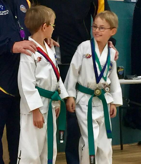 WINNING TWINS: Brothers Jack and Justin Sirre are all smiles at the USMA taekwondo tournament in Oakleigh. The pair won five medals for the day. Picture: Kym Sirre. 