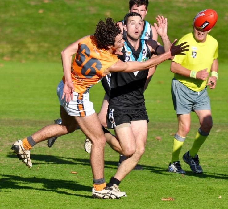 NEW CHALLENGE: Swifts coach Scott Carey wrestles with a Southern Mallee Giants player. The Baggies are supportive of the Giants' move. Picture: Georgia Hallam. 