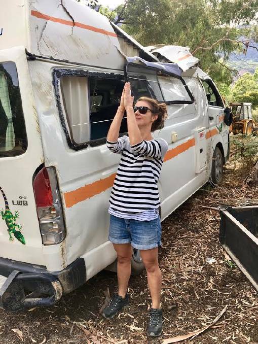 GRATEFUL: Jackie Armstrong thanks the heavens after her camper van rolled three times on a hill. 