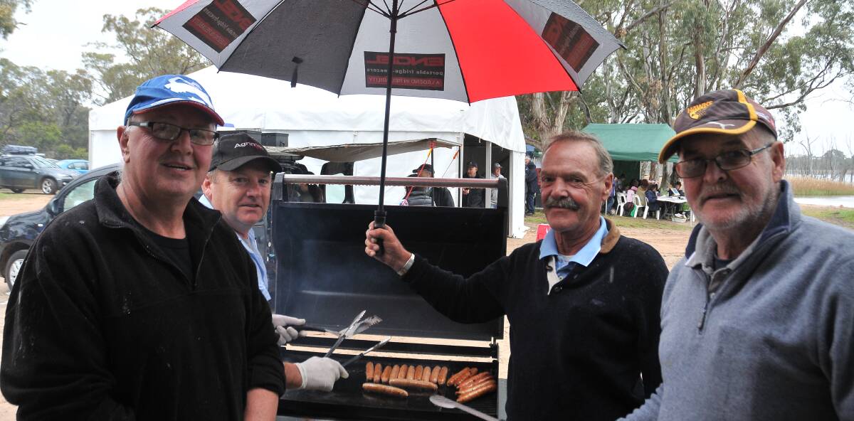 HELPING HANDS: Stawell Angling Club members Gary Miller, Darren Smith, Dave Wilson and Ray Howard provided sausages for party goers.
