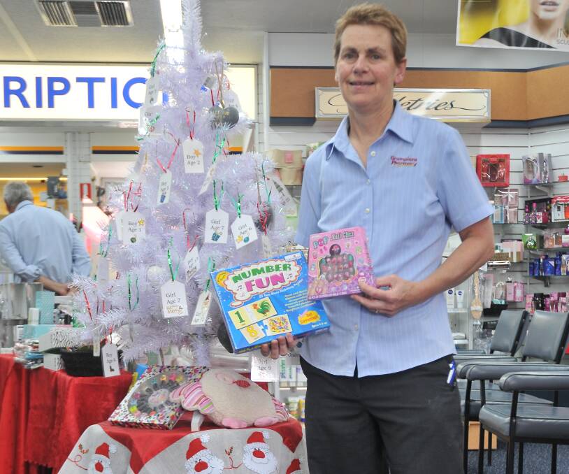 GIVING TREE: Grampians Pharmacy pharmacist Susan Gunnell beside the Wishing Tree, which aims to provide gifts to impoverished children. Photo: Anthony Piovesan 