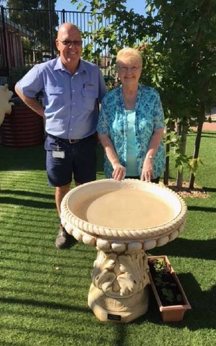 DONATION: Paul and Dot Tangey with the bird bath they will donate to Eventide Homes' sensory garden in memory of Tom Tangey. 