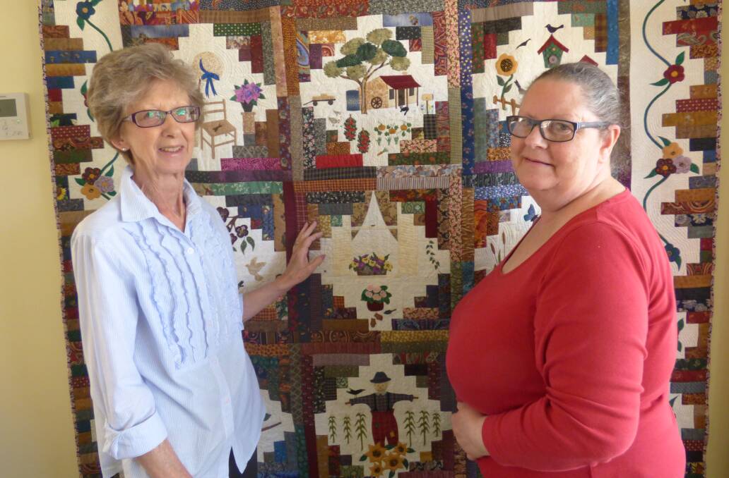 DONATION: Eventide Independent Living resident Lola Petschauer with resident Shona Podmore in front of the new quilt wall hanging display. 