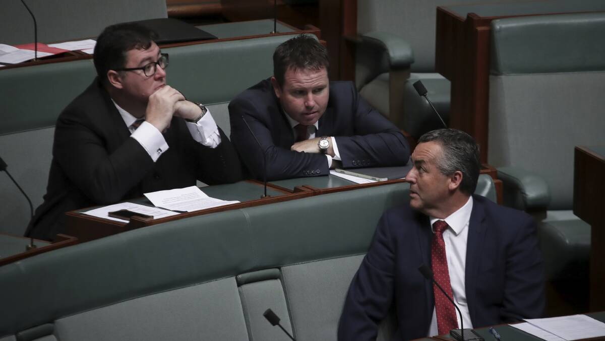 Nationals MP George Christensen, Andrew Broad and Darren Chester in discussion ahead of Question Time at Parliament House Tuesday. Photo: Alex Ellinghausen