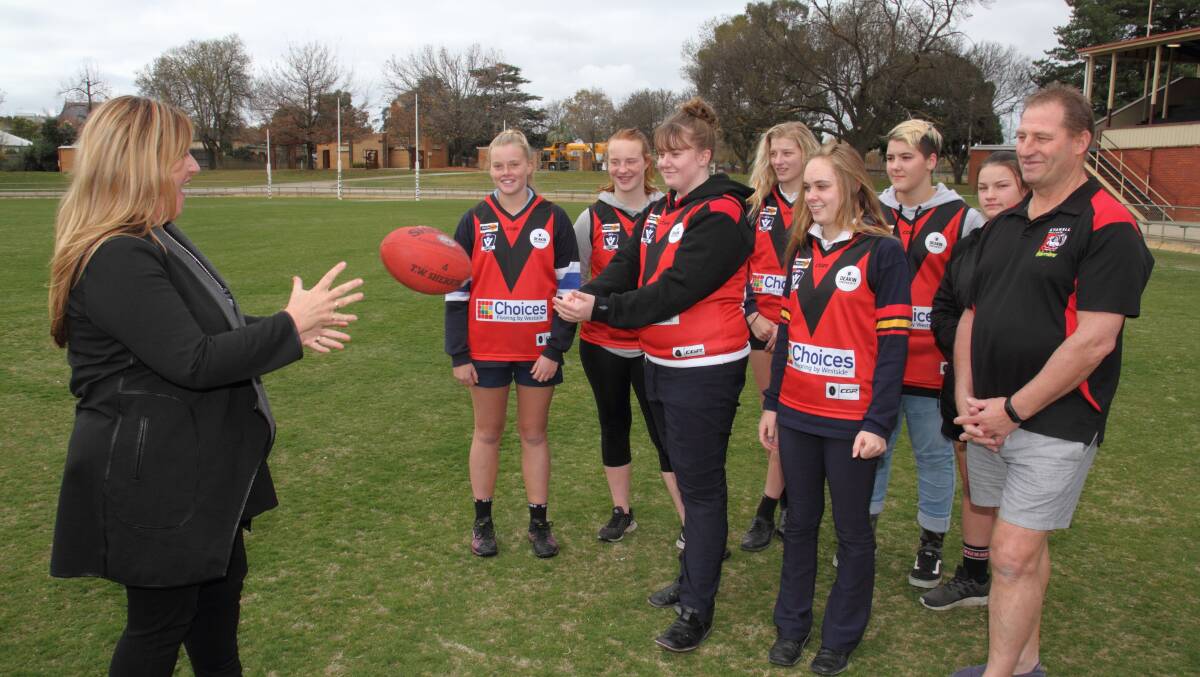 Parliamentary Secretary for Regional Victoria Danielle Green catches a handball from the Stawell Football Netball Club girls football team after announcing a $3000 equipment grant for the side on Monday. Picture: PETER PICKERING