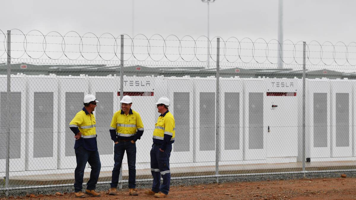 Construction workers at the launch of Tesla's 100 megawatt lithium-ion battery at Jamestown, north of Adelaide, In December. Picture: AAP/DAVID MARIUZ.