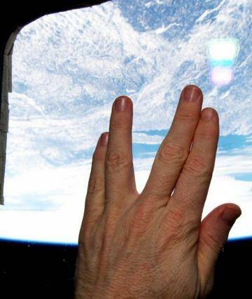 Astronaut Terry Virts gives the Vulcan salute from the cupola of the International Space Station in a tribute to actor Leonard Nimoy. Photo: Terry Virts