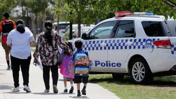 Parents take their children from Aitken Creek Primary School in Craigieburn, Melbourne, on Tuesday. Photo: Wayne Taylor