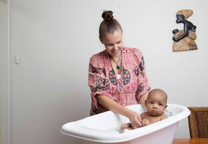Kelly Boateng gives her son Kingston a bath. Kelly has opted for the water birth method for Kingston and her two other children. Photo by Cole Bennetts