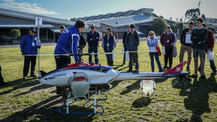 Students learn about the Fazer unmanned helicopter at AgVision in Homebush. Photo: Brendan Esposito