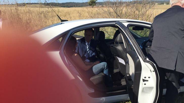 Bill Shorten comforts a passenger at the scene of car crash near Cessnock and Maitland in NSW. Photo: Belinda-Jane Davis